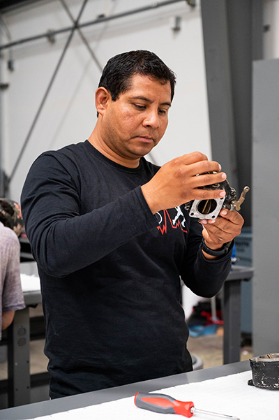 Student working on plane part