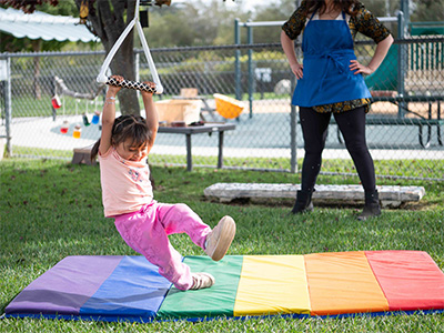 child on hanging swing